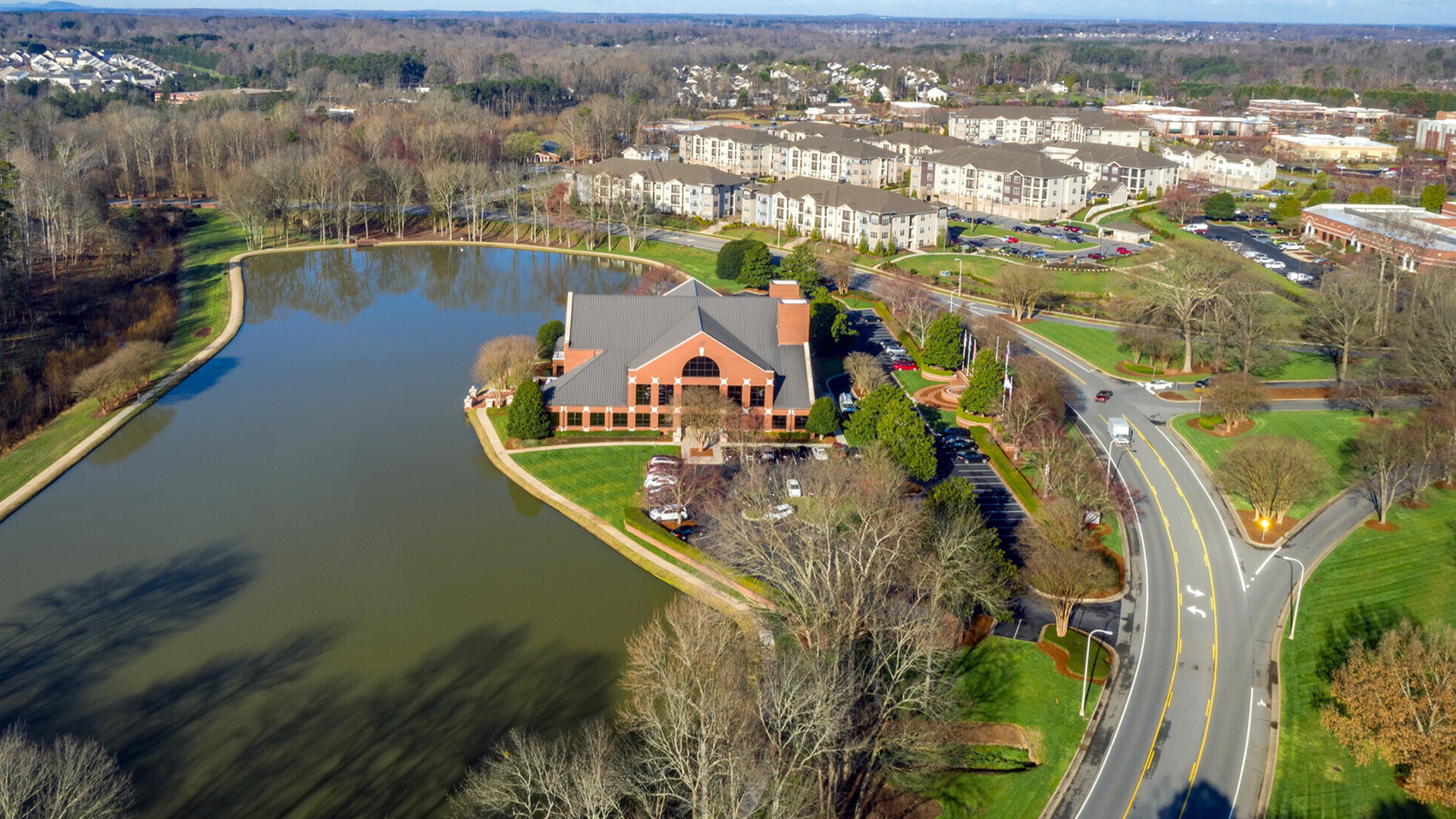 Aerial image of building at neighboring pond of water