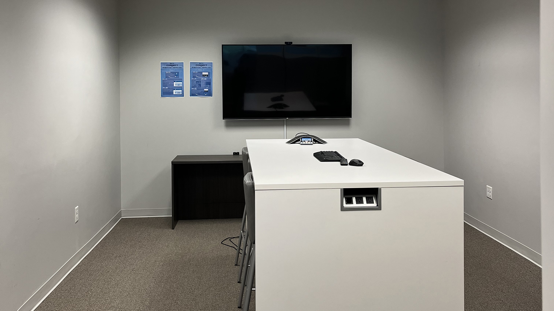 Meeting room with bar height table and tv