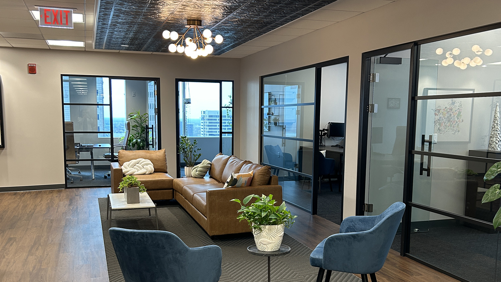 Common area with a couch, chairs, and unique light fixture at 10 S LaSalle in Chicago IL 