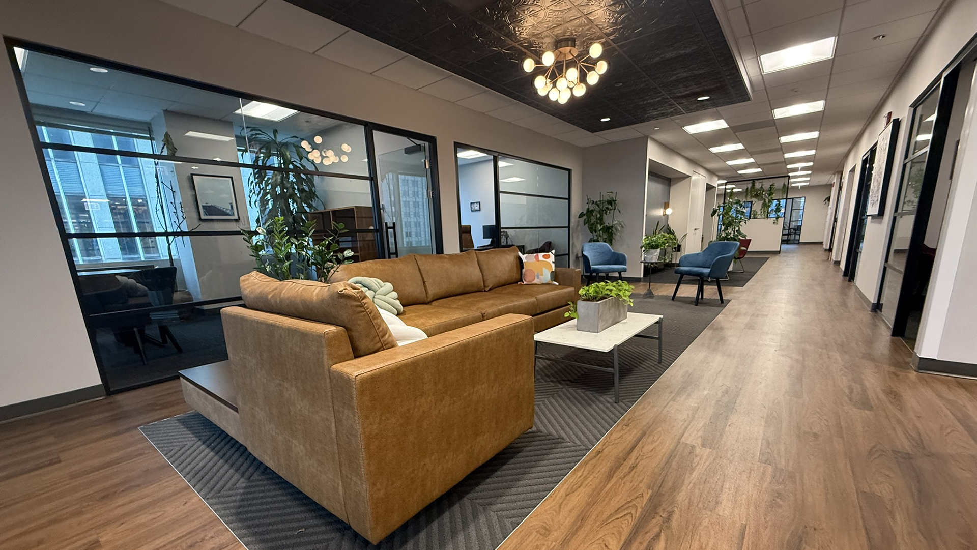 Common area with chairs, couches, and a light fixture at 10 S LaSalle in Chicago IL 