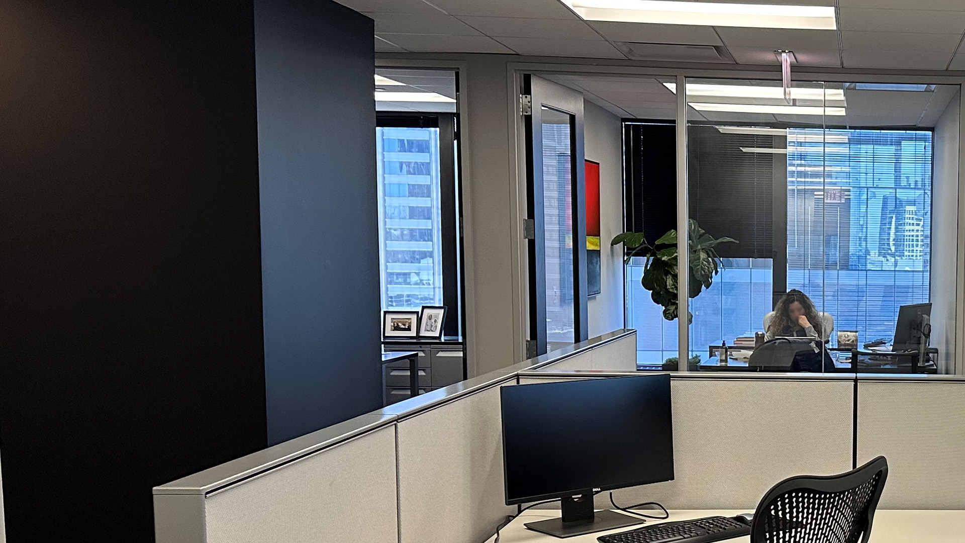 Interior work station looking into an office that overlooks the city at 150 N Wacker Dr