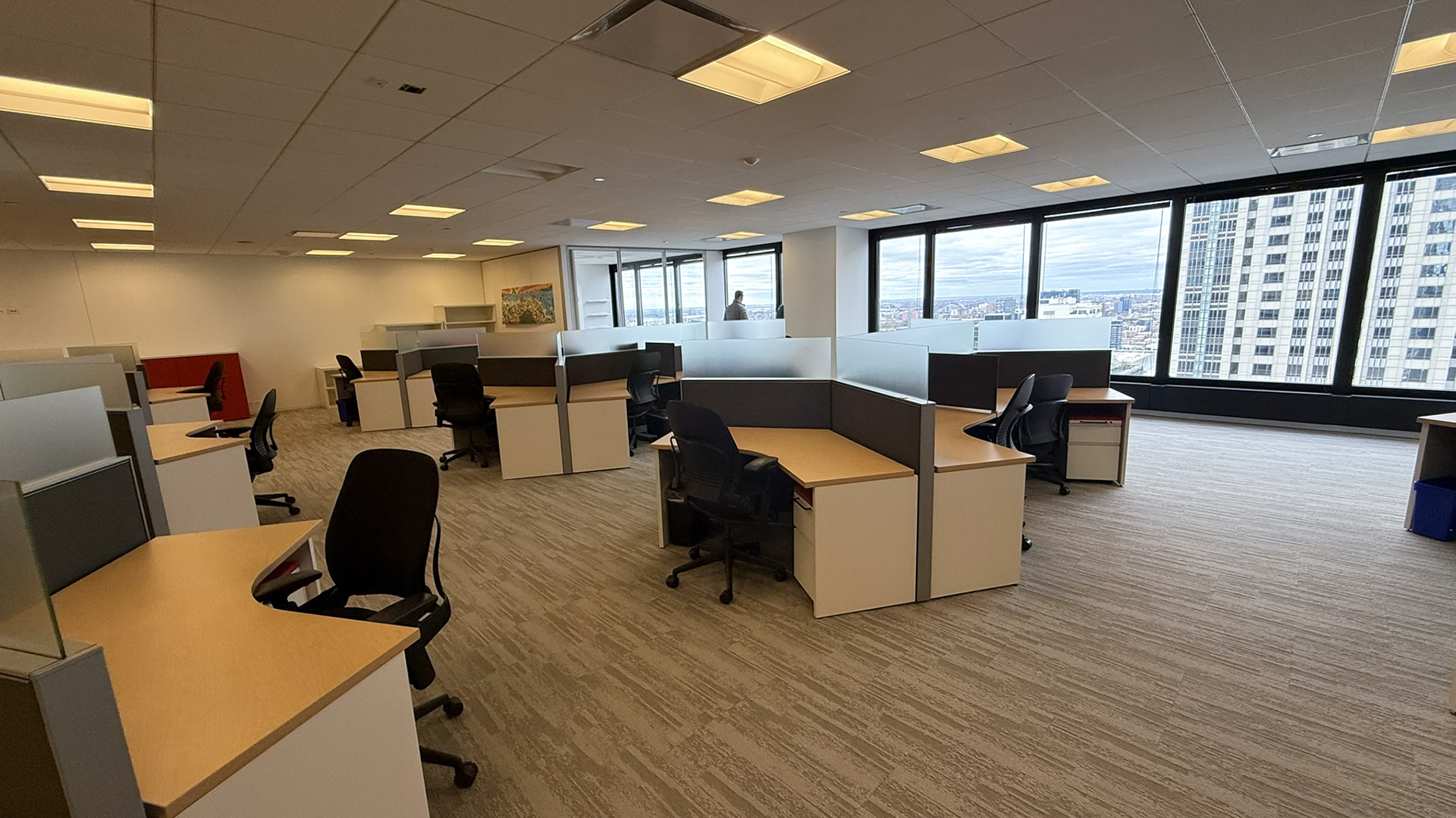 Interior individual desks in an open office layout with city views 