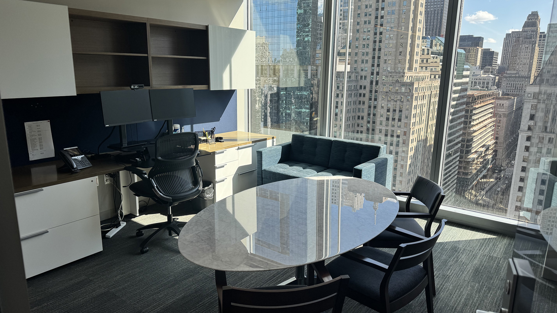 Office with table, desk, computers and a view of downtown Chicago at 300 N LaSalle