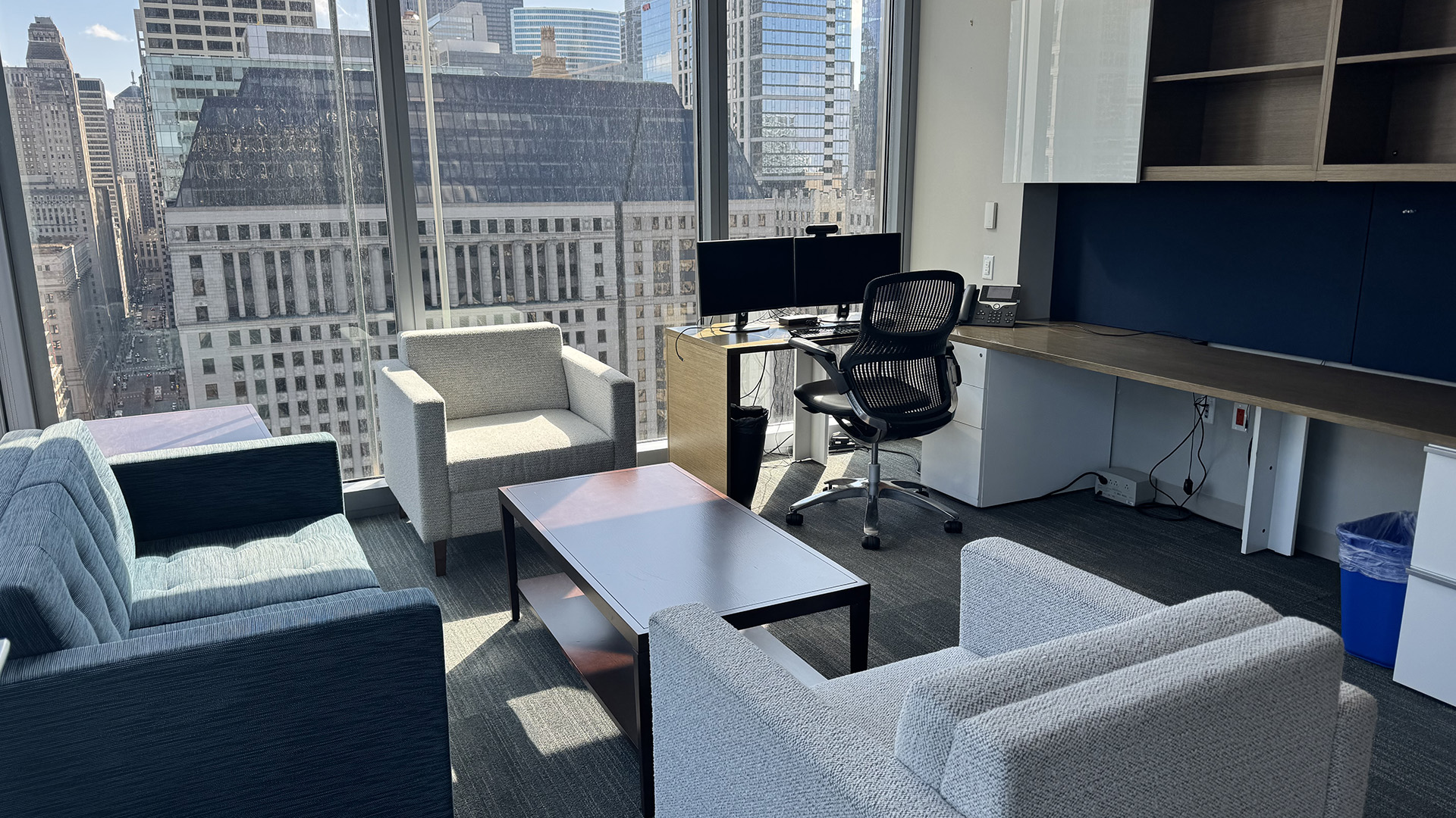 Office with three chairs, a desk, and a computer with floor to ceiling windows overlooking downtown chicago at 300 N LaSalle