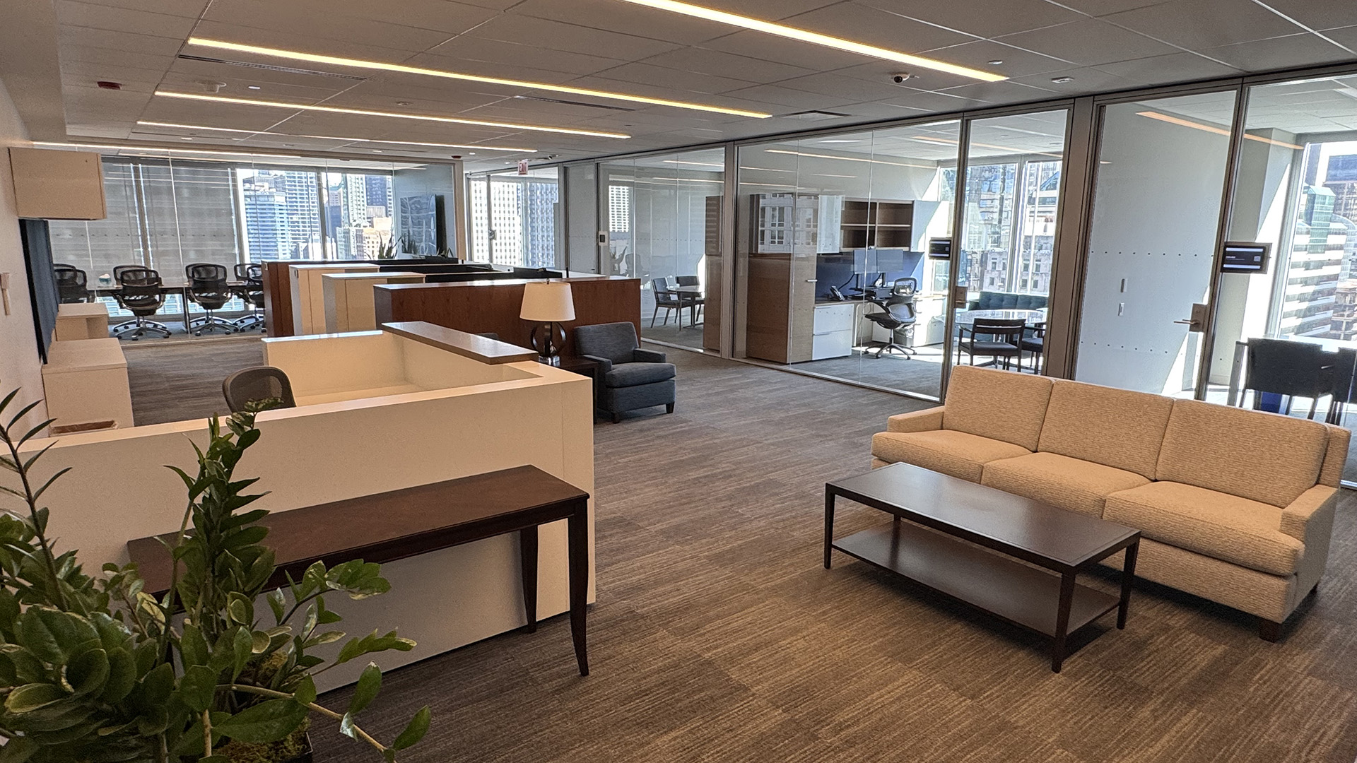 Open work area with a couch  and table and work stations in the background at 300 N Lasalle