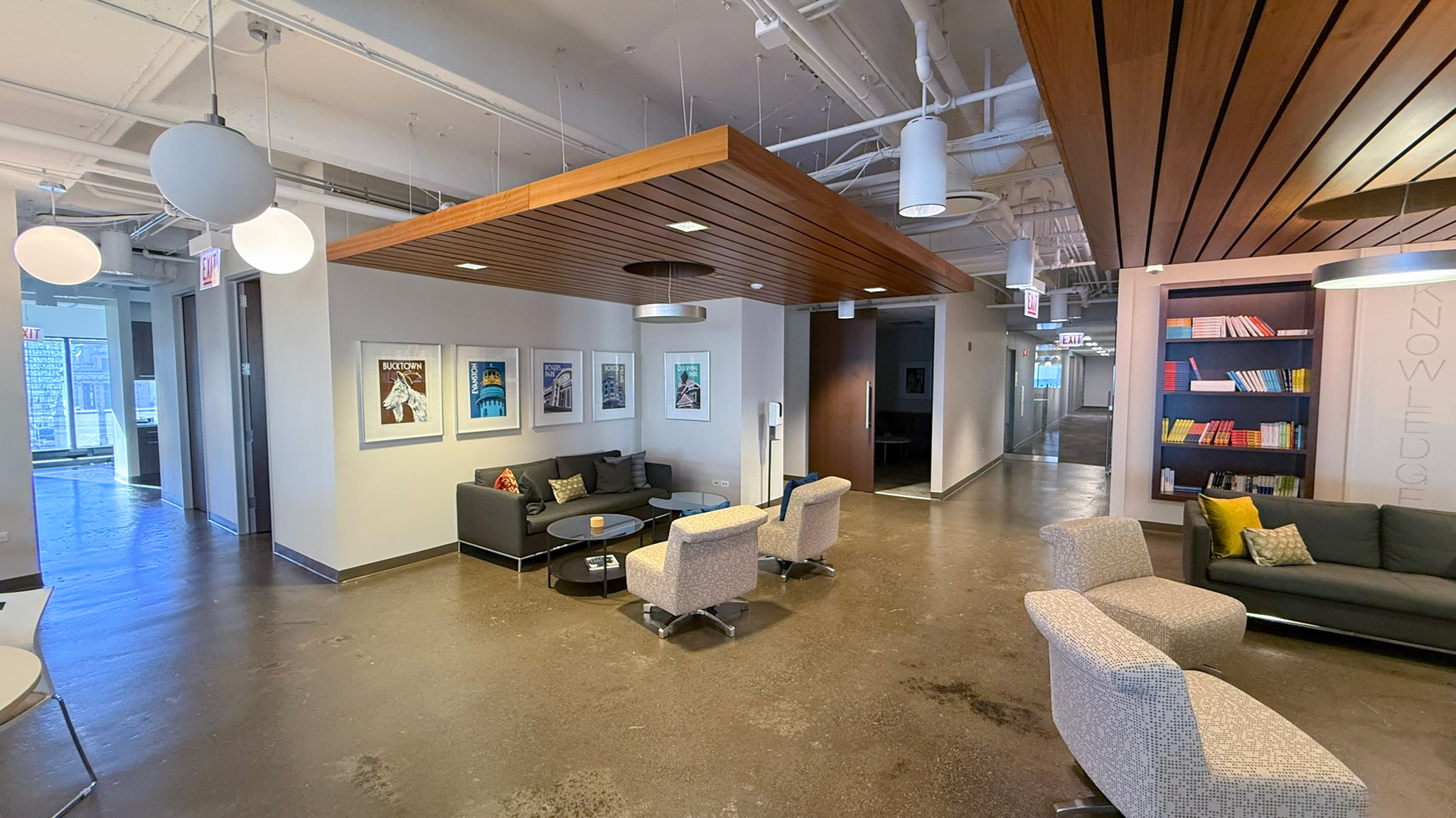 Common area with seating, book shelves, and art on the walls at 444 N Michigan 