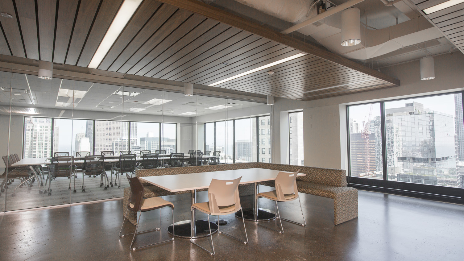 Kitchen and common area with tables and chairs and city views at 444 N Michigan