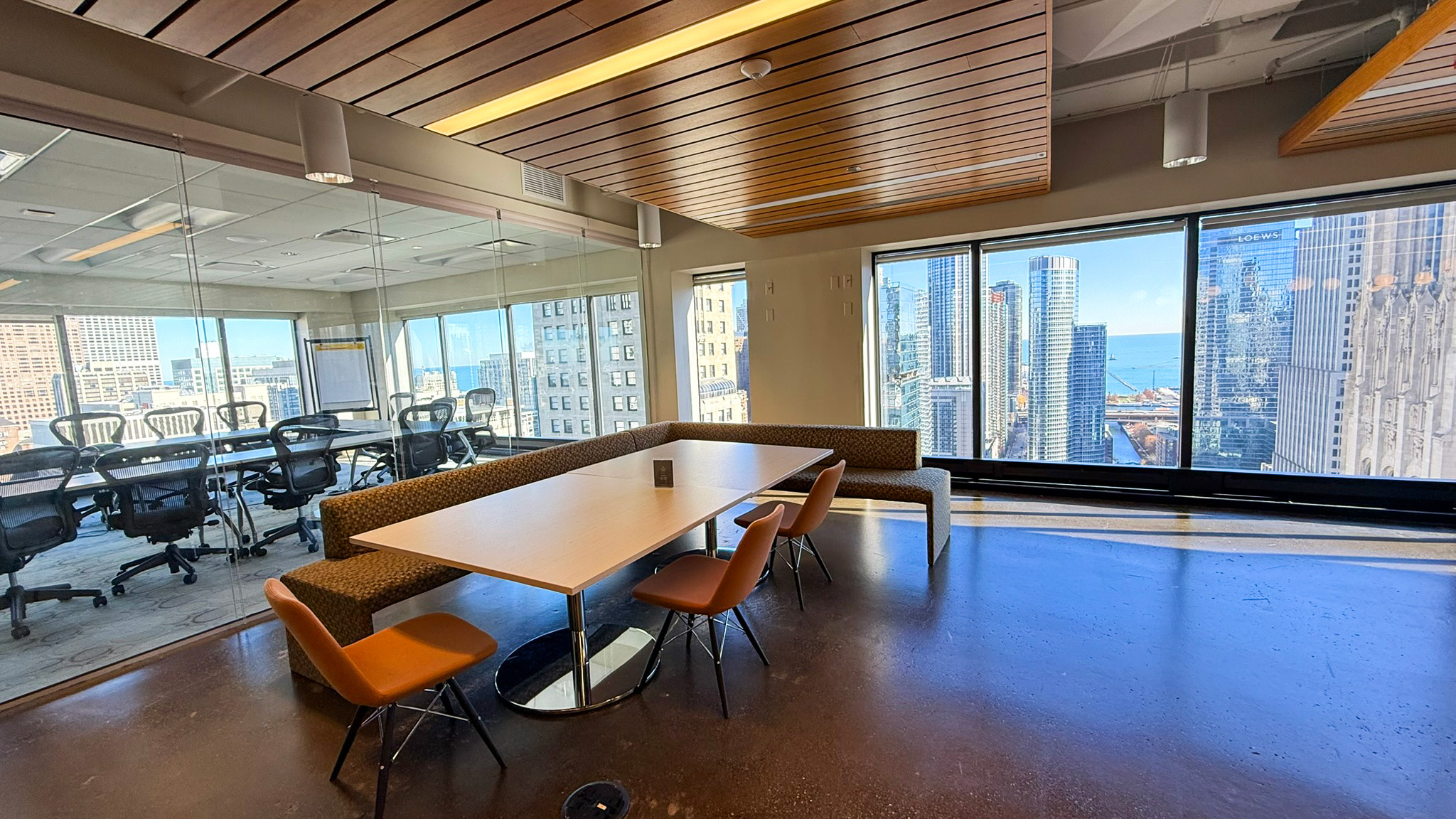 Kitchen area outside of glass meeting room with city views at 444 N Michigan
