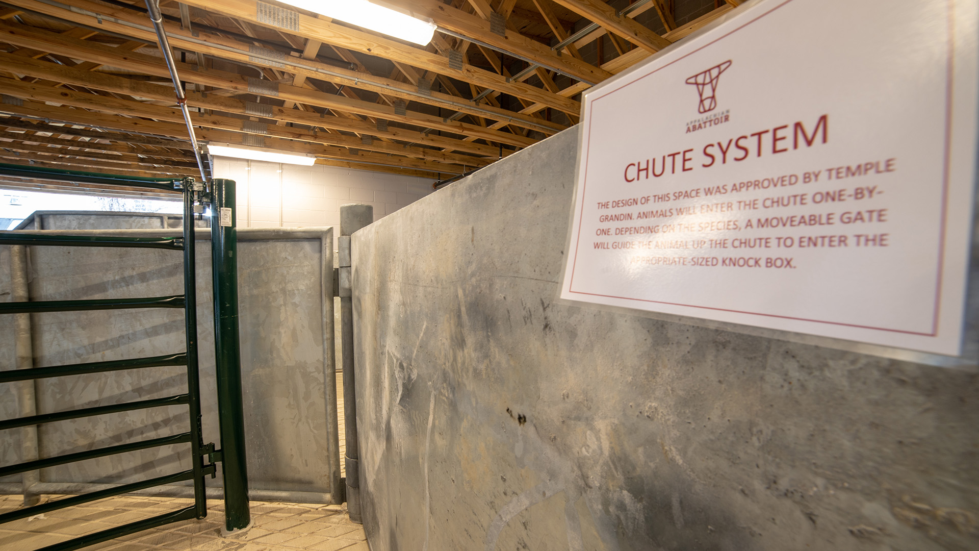Storage area instead of of 4808 Kanawaha with fence visible and sign that says "chute system"