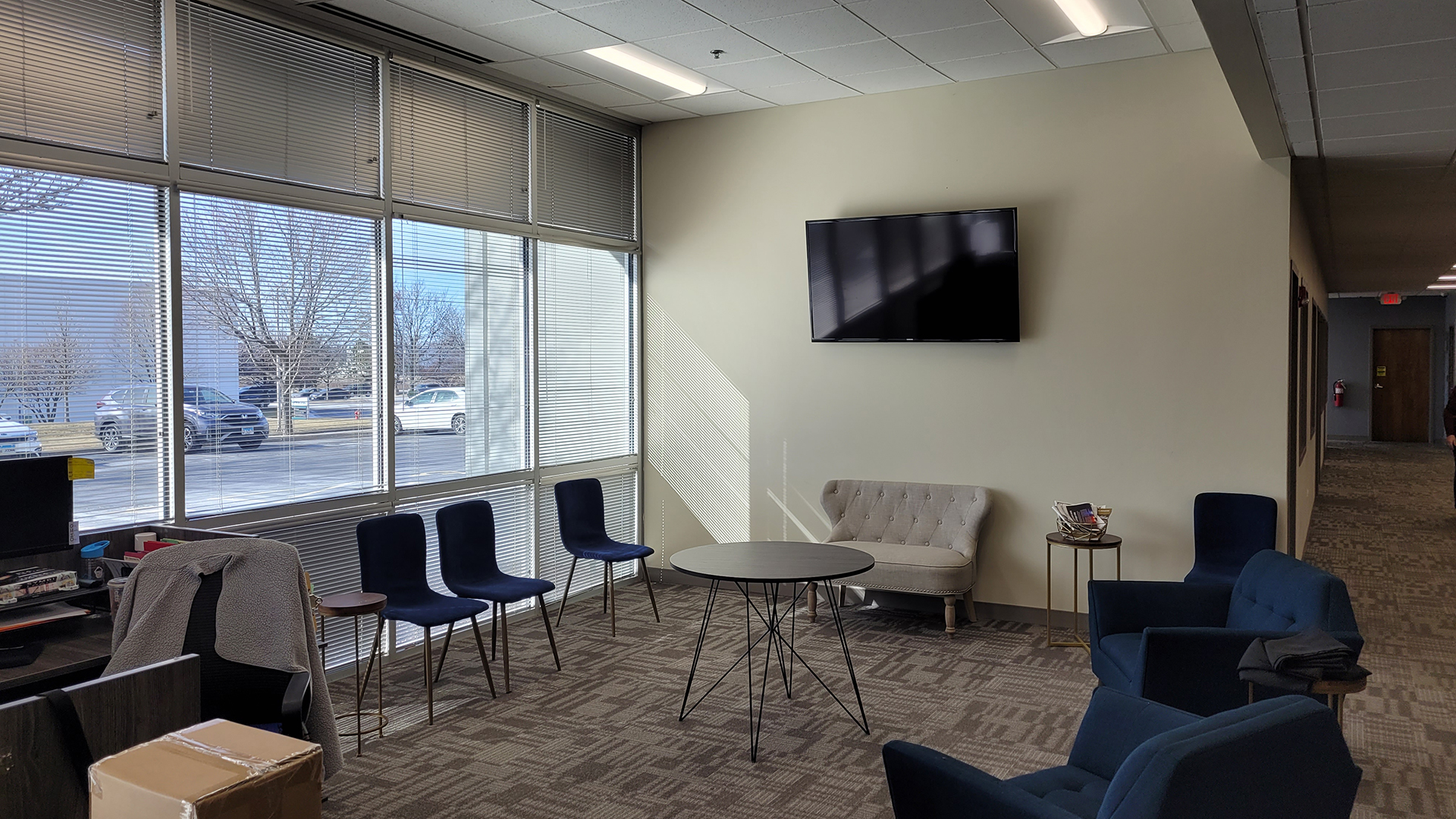 Interiror reception area with chairs and a TV at 700 Gateway