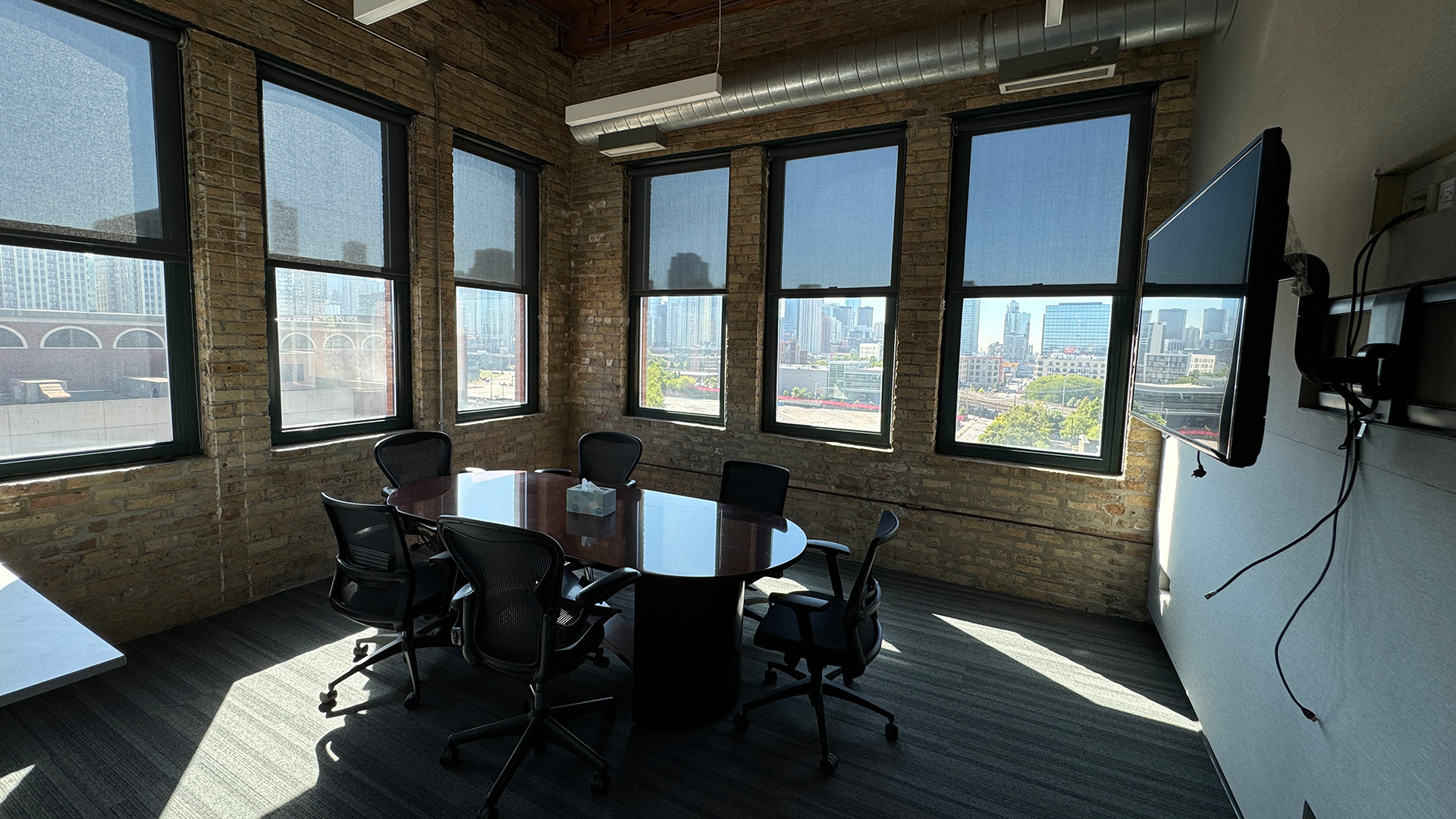 Corner office with nice view, conference table, and TV at 770 N Halsted
