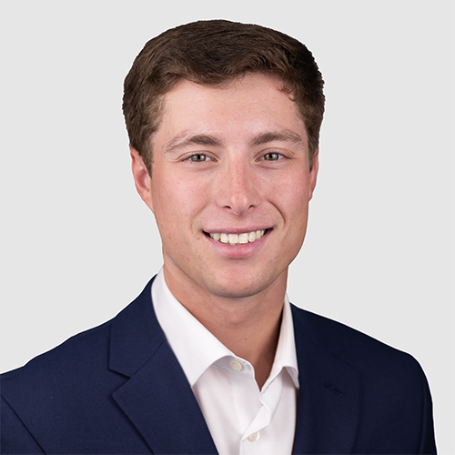 Kyle Catttaneo Official Headshot - Kyle is wearing a black suit 