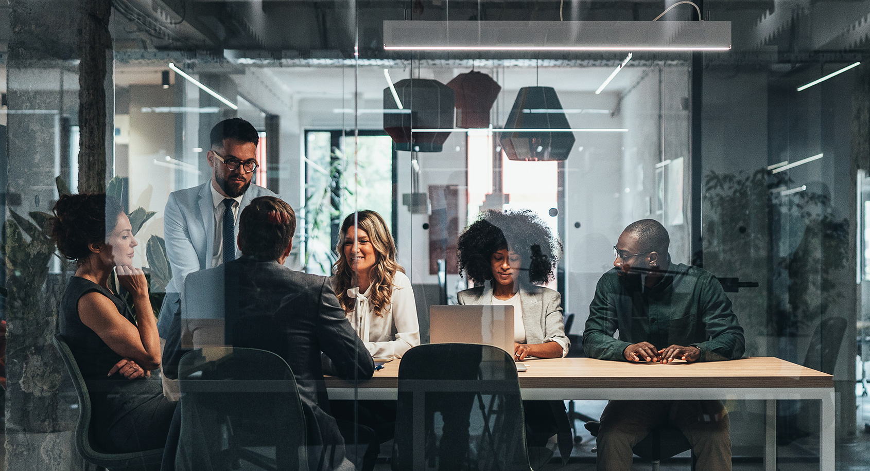 Business professionals collaborating in a glass-walled conference room,  strategic consulting team meeting in modern office
