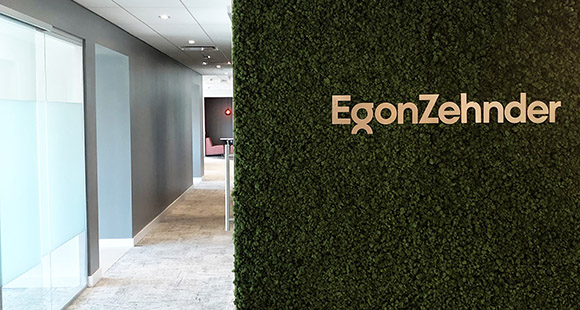 Egon Zehnder logo on green leaf wall