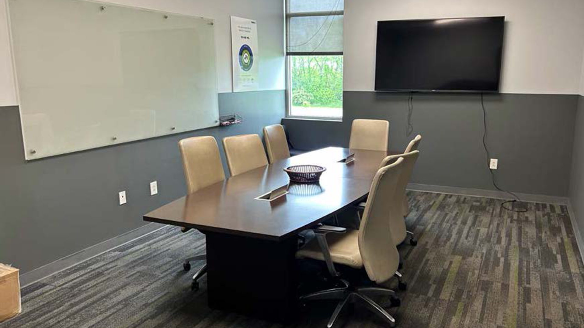 conference with large table, chairs, and tv at 715 beechcroft st building