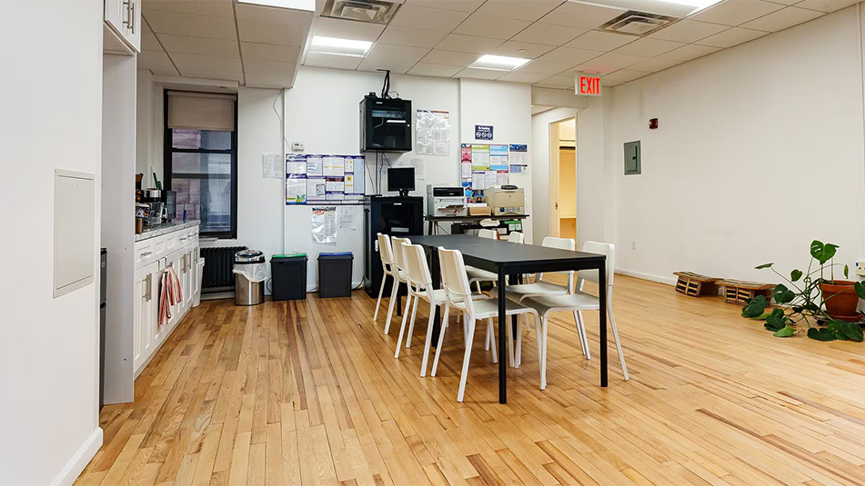 Open Kitchen area with hardwood flors and table with six chairs