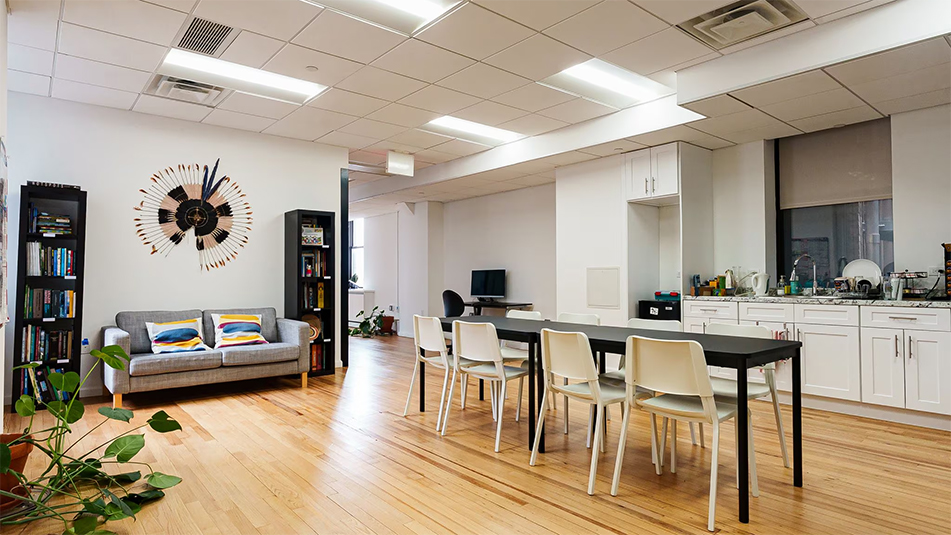 View of open kitchen with a sofa on the back wall