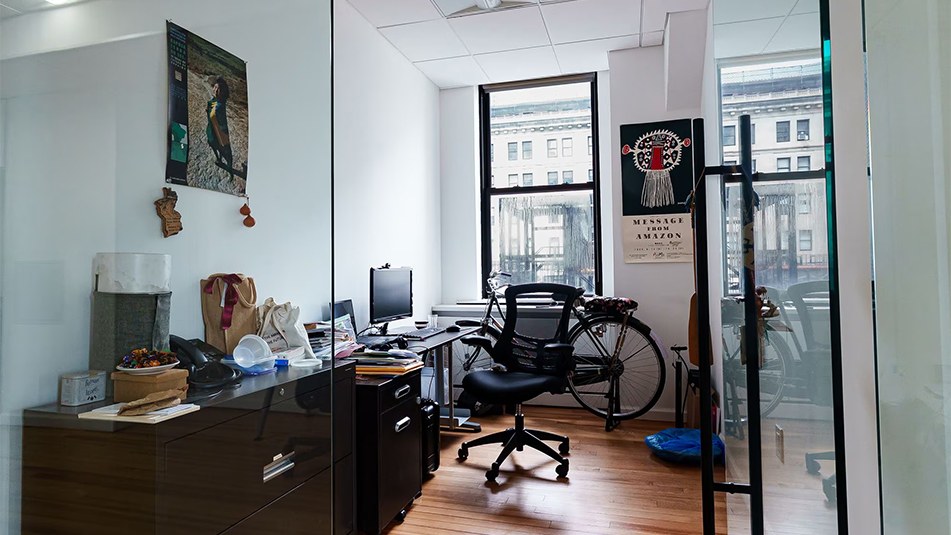 Looking into an office with a long desk and chair