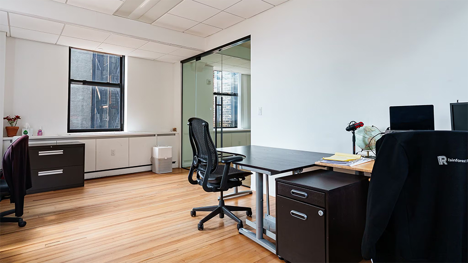 View of large area with two desks and filing cabinets