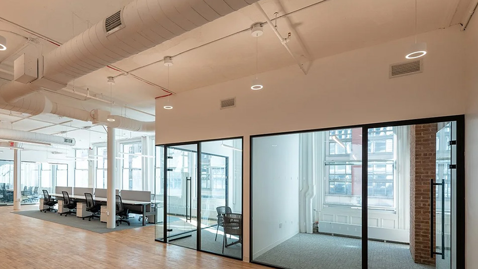 View of glass walled conference room, workstations and offices
