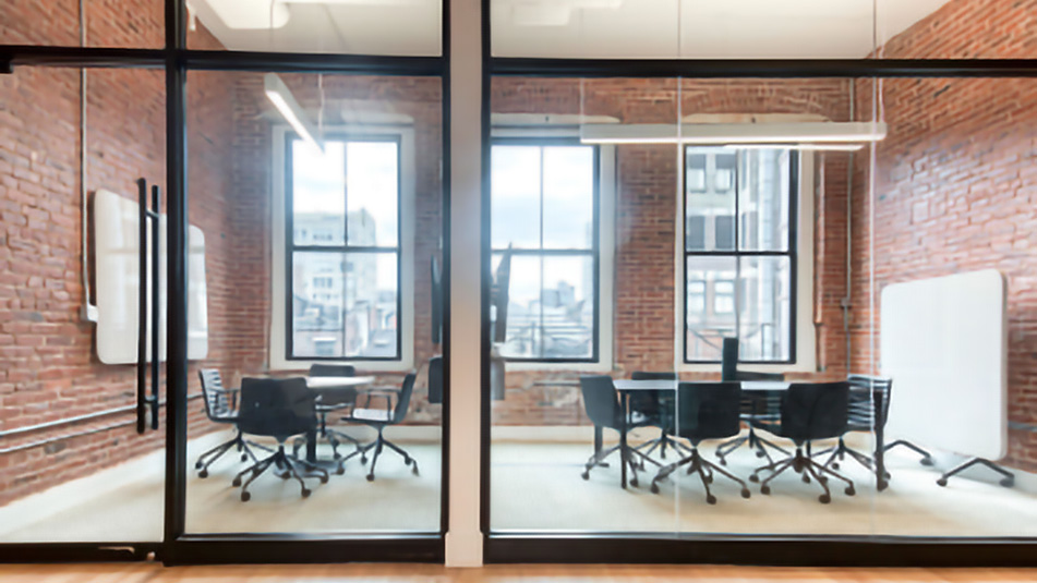 View of conference rooms with brick walls and glass fronts