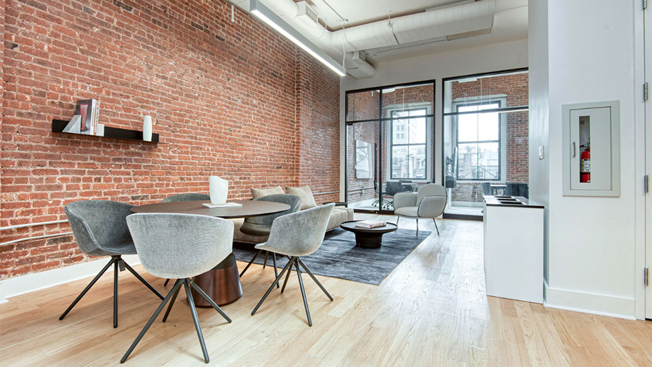 View of a seating area with a table and chairs and sofa